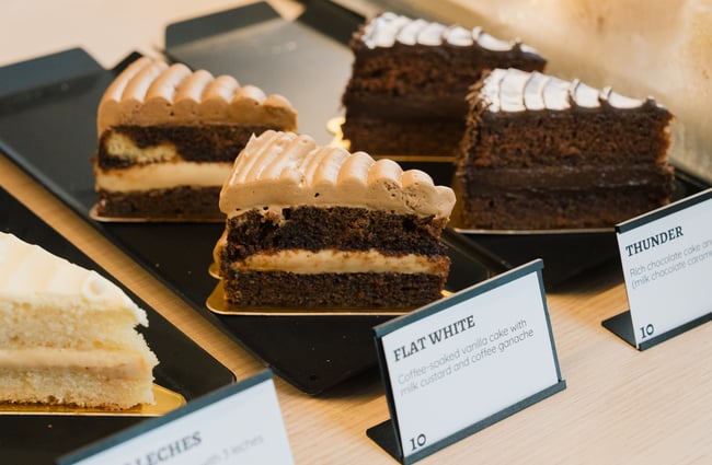 Close up of flat white cake in cabinet at Dhi Ferrari in Christchurch.