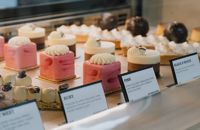 Pink desserts in the cabinet at Dhi Ferrari.