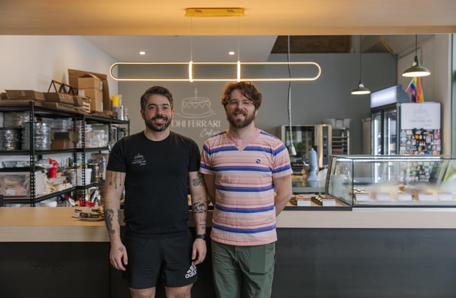 Dhi and his partner Sam in front of Dhi Ferrari Cakes.