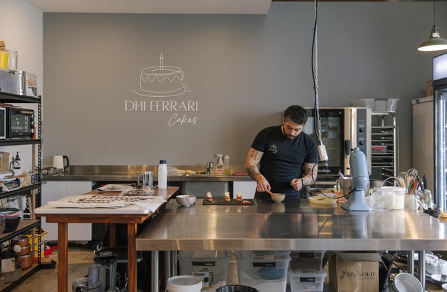 Dhi working in the kitchen at Dhi Ferrari Cakes.