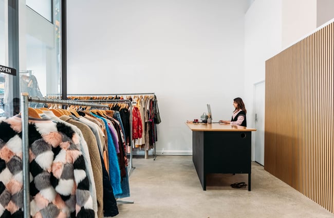 Sales manager stands behind the front counter at Different Avenue.