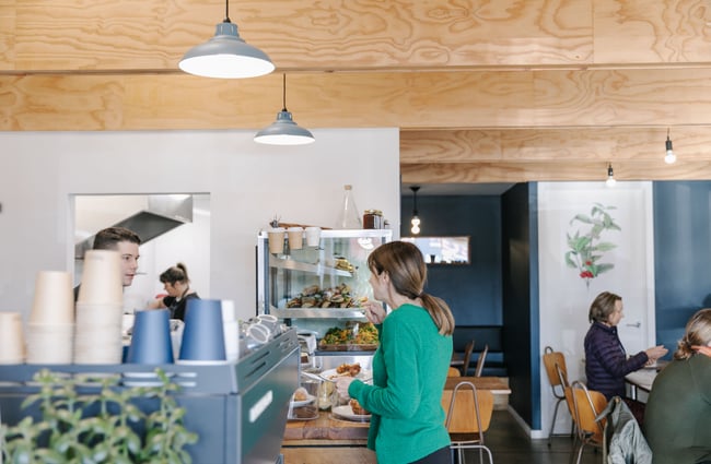 Customer talking to man behind the counter at DispenseE Espresso in Christchurch.