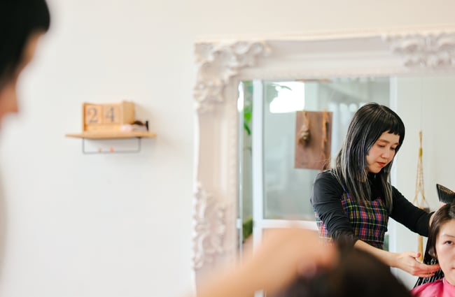 Miki and client in the mirror at Doki Hair Salon.