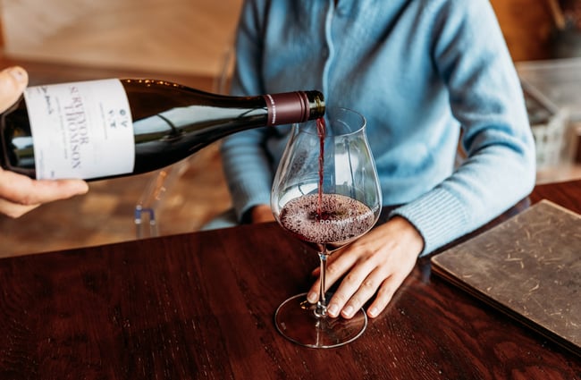 Glass of wine being poured for a customer at Domaine-Thomson Wines Cellar Door.