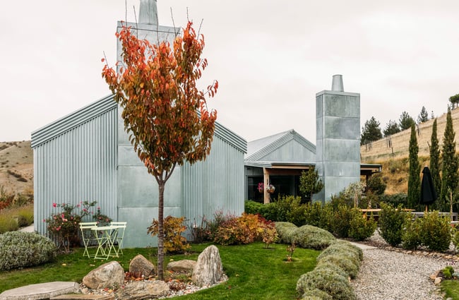 Exterior of Domaine-Thomson Wines Cellar Door set against the Central Otago landscape.