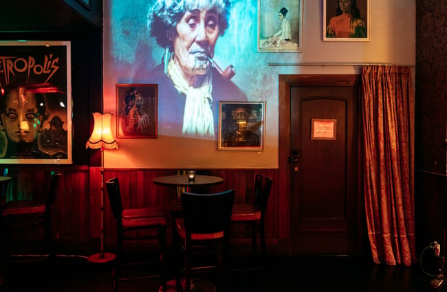 A projected image of a Maori woman on a wall.