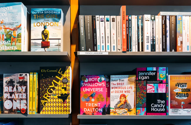 A close up of books on a shelf.