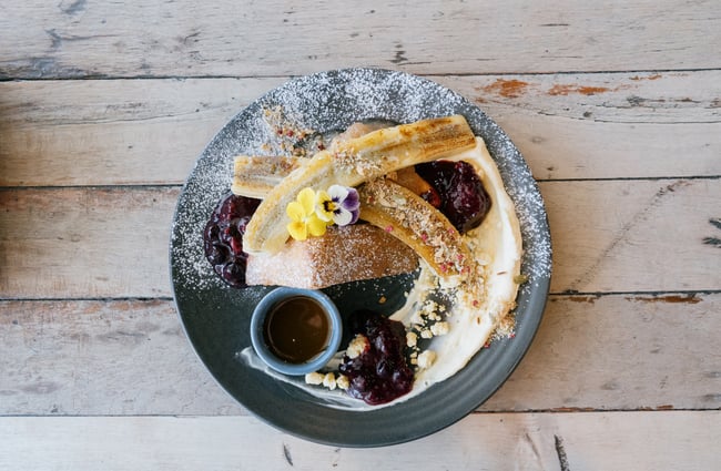 Close up of French Toast with banana and icing sugar at Dose Diner in Christchurch