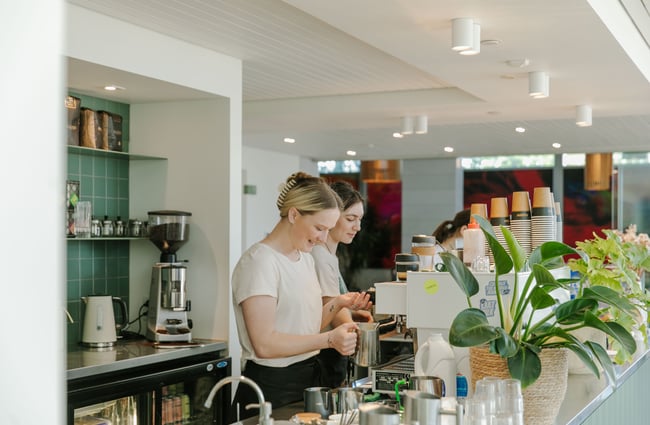 Two female staff members working behind the counter at Doubles.