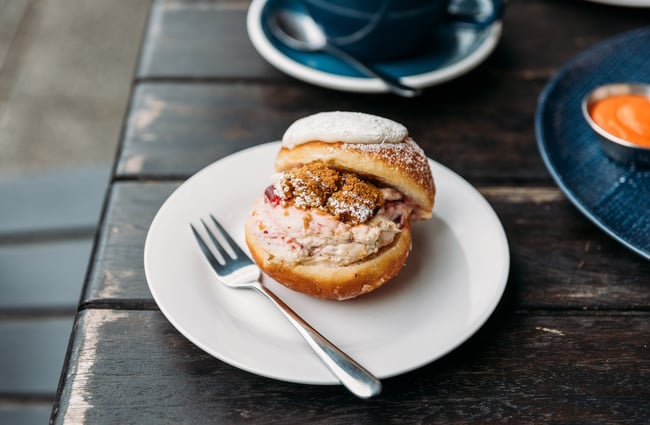 Cream-filled donut on a plate at cafe