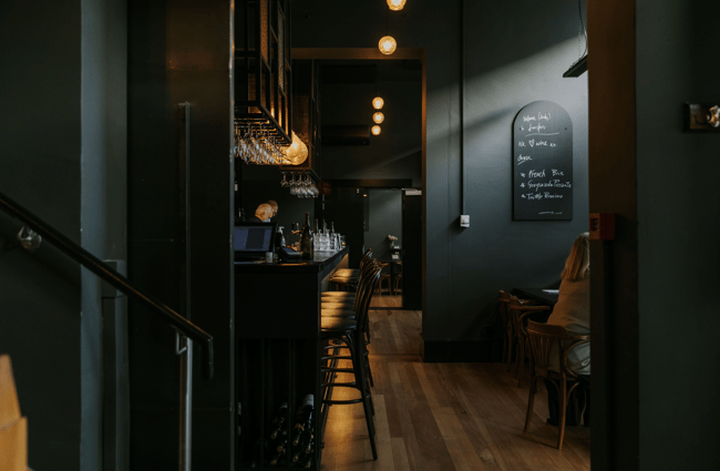 Dark moody image inside Downstairs where their is bright feature lighting.