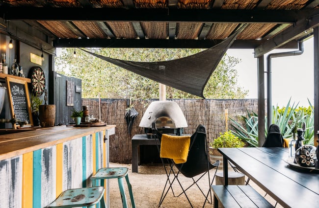 An outdoor kitchen and pizza oven.
