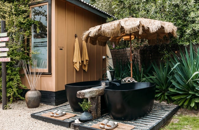 Black bath tubs and a small hut.