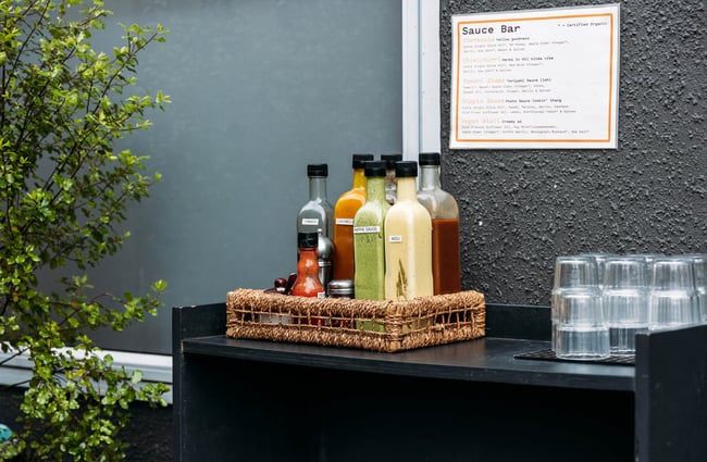 Bottles of sauces to use at the front counter at Dripping Bowl.