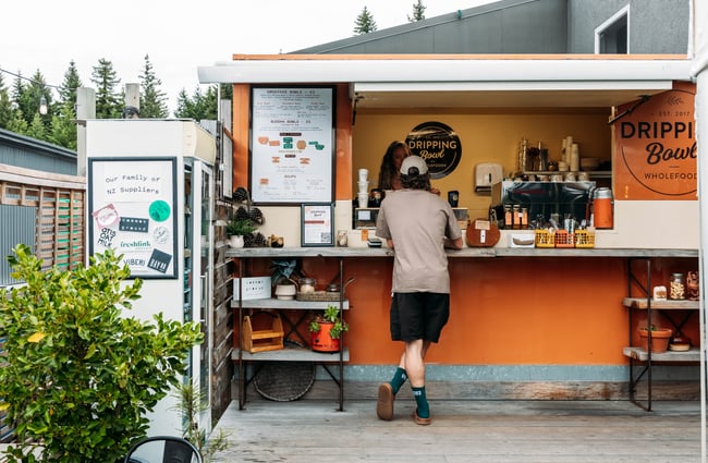 Customers stands at the front counter at Dripping Bowl, Wānaka.