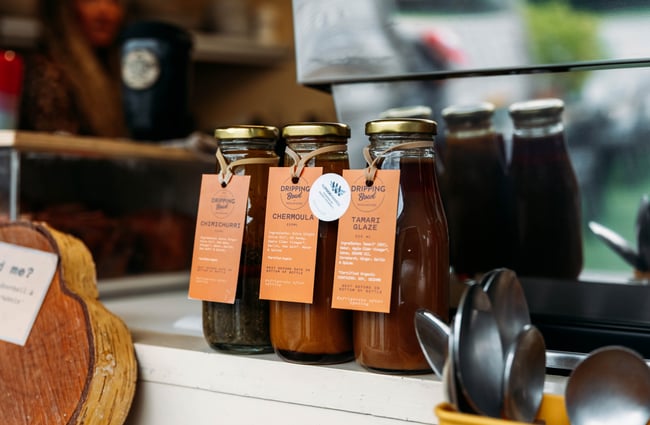Homemade Dripping Bowl sauces for sale on the counter at Dripping Bowl.