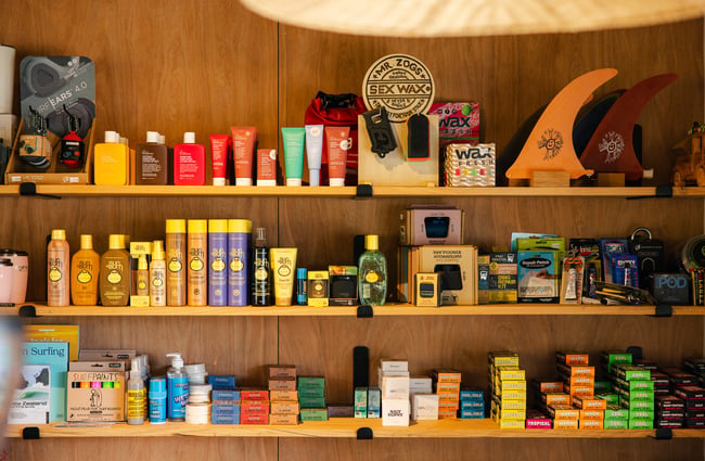 Shelf of products at Drop In Surf & Supply.