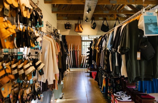 Racks of clothing and shoes at Drop In Surf & Supply.