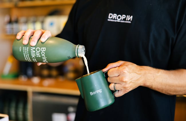 Barista using Boring Oat Milk at Drop In Surf & Supply.