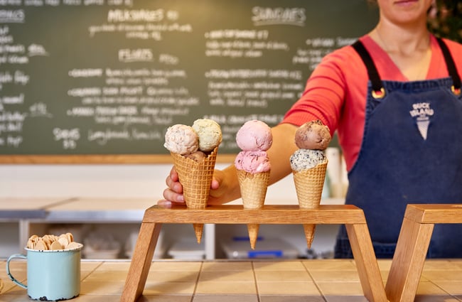 Shop assistant placing ice cream cones on the counter at Duck Island.