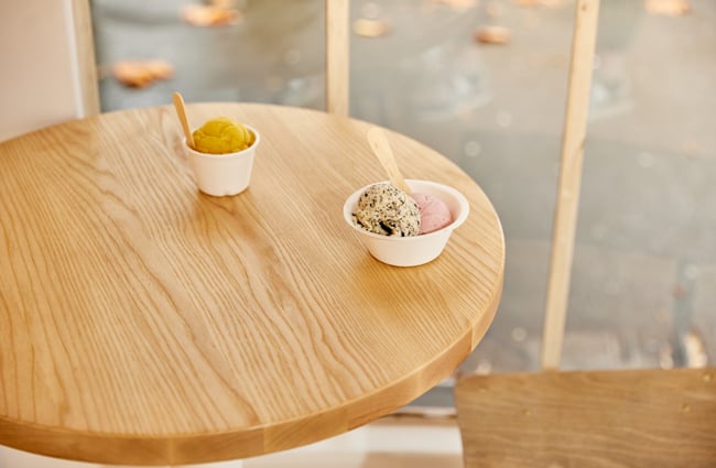 Scoops of ice cream in cups sitting on a table at Duck Island.