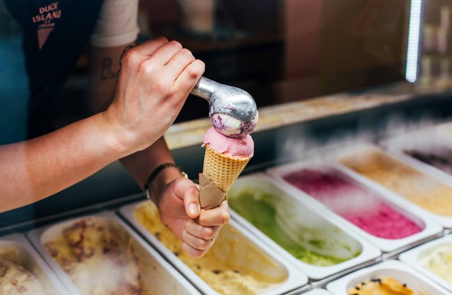 Close up of someone scooping ice cream.