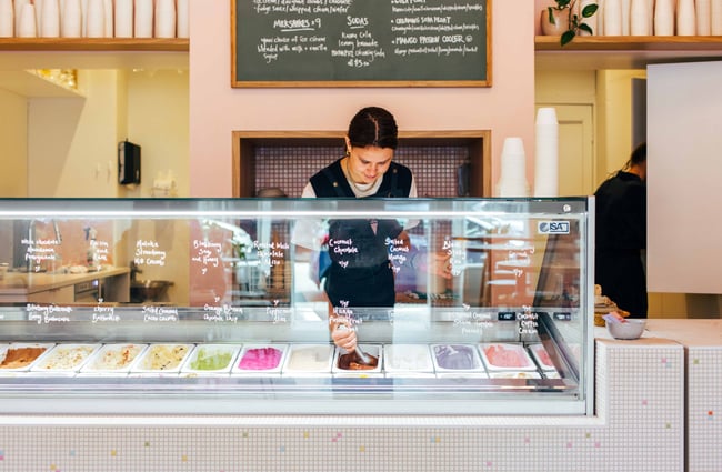 Woman behind the ice cream counter.