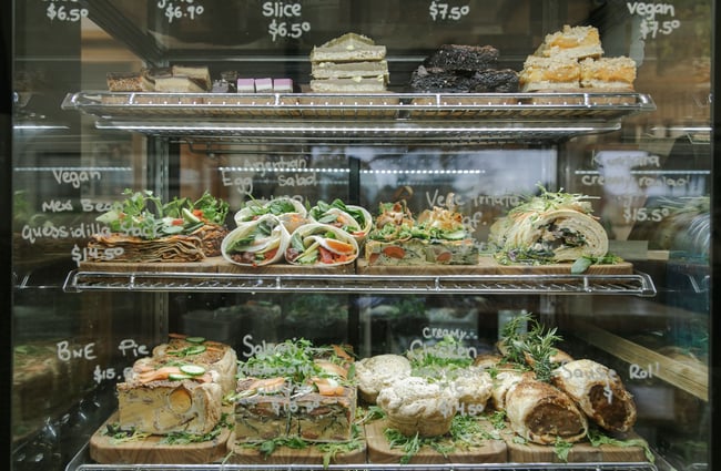 Close up of sweet and savoury goods in the refrigerated cabinet at Dune Cafe.