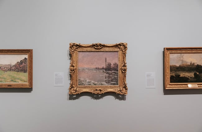 Close up of artworks on a wall.