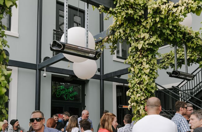 People drinking outside the Emerald Gin Room at Dux Central, Christchurch.