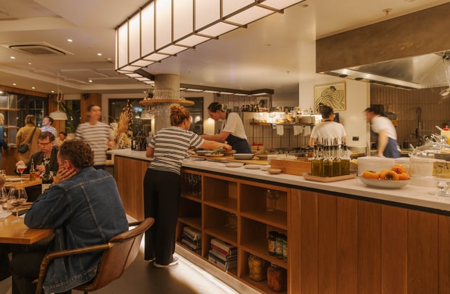Dining room has a view of the open kitchen at Earl.