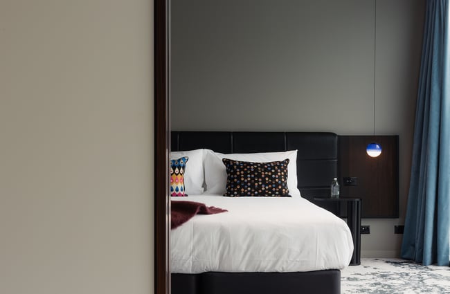 View of the bed in hotel room at Ebb, Dunedin.