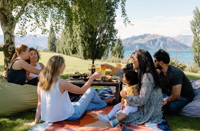 Group of people enjoying a picnic outside at Edgewater.