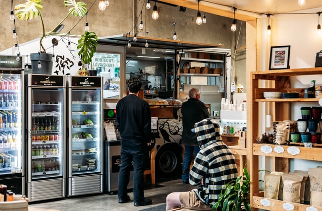 Customers ordering coffee at the front counter at Elemental Eats.