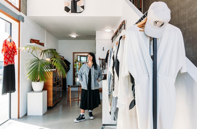 A woman standing inside a shop.