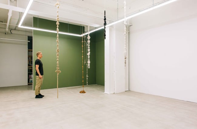 A man browsing the works at Enjoy Art Gallery.