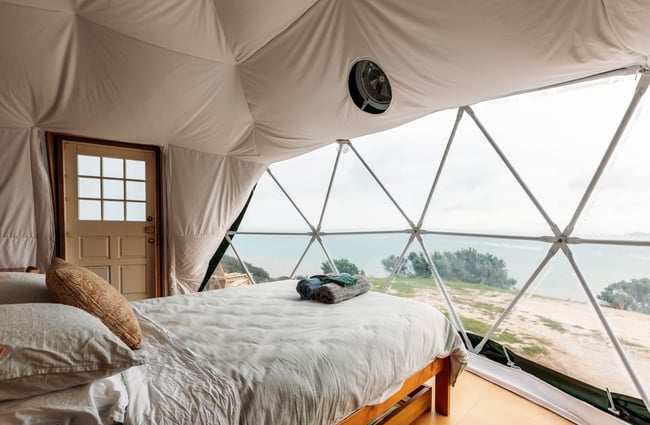 A view of a bay from a bed inside Escarpment Domes.