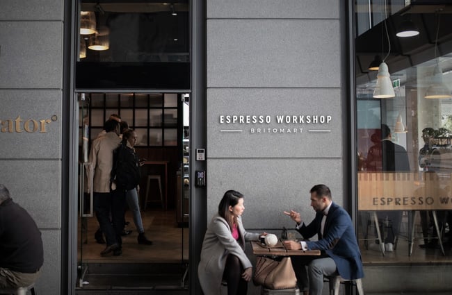 Espresso Workshop sign with customers underneath.