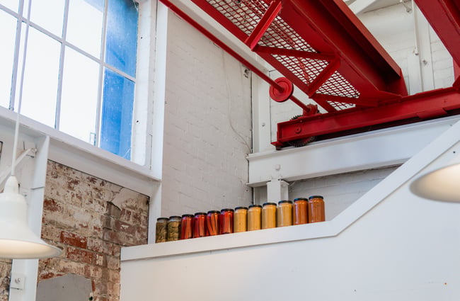 Jars of preserves lined up in a row.