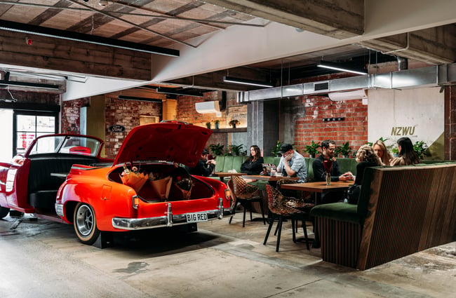 Red 1952 Chevy in the middle of the cafe space at Eva's Garage.
