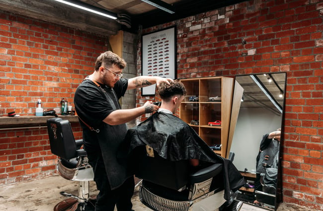 Barber at work in Eva's Garage.
