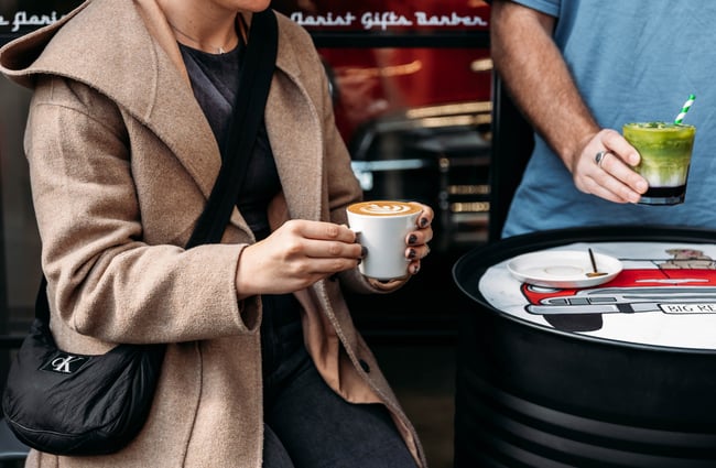 Customers enjoying a coffee and matcha outside at Eva's Garage.