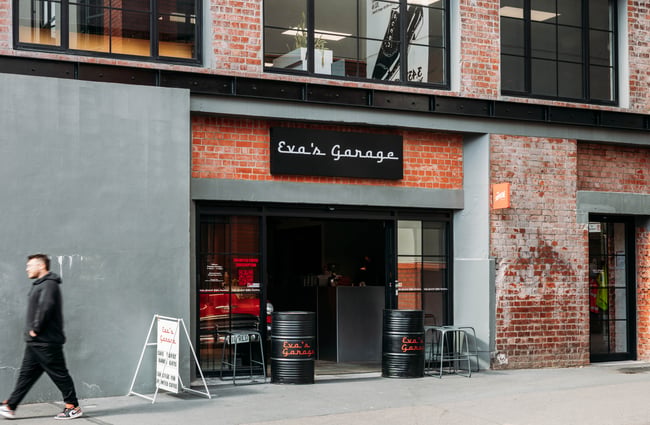 Customer walking past Eva's Garage exterior.