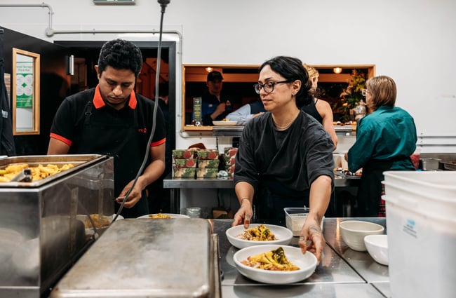 People preparing food in the kitchen at Everybody Eats.