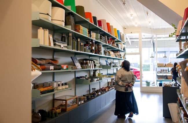 Customer browsing tall shelves at Everyday Needs in Ponsonby Auckland