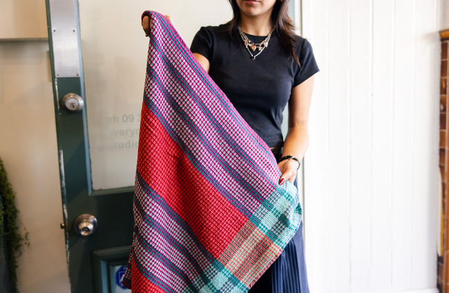 Woman holding woven towel at Everyday Needs in Ponsonby Auckland