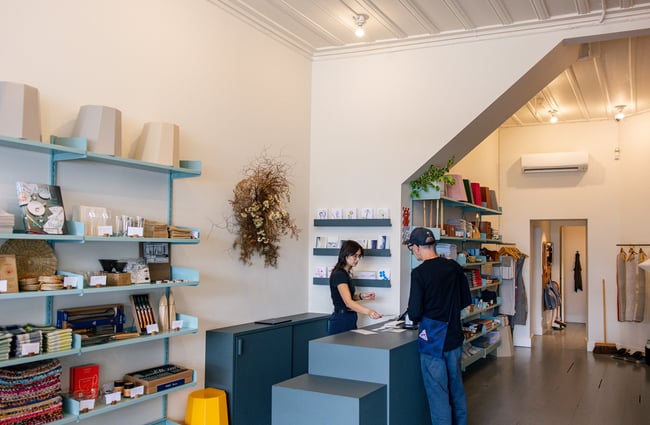 Woman serving customer at counter at Everyday Needs in Ponsonby Auckland