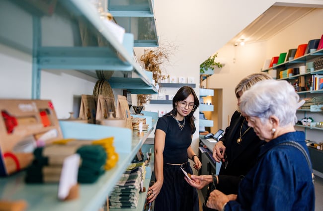 Woman helping customers in store at Everyday Needs in Ponsonby Auckland