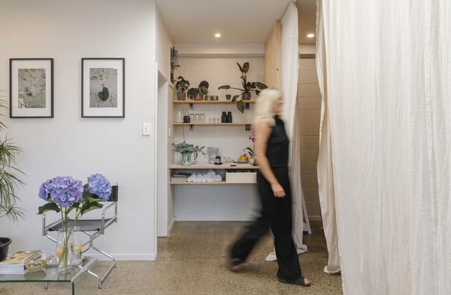 A woman walking inside a skin clinic.