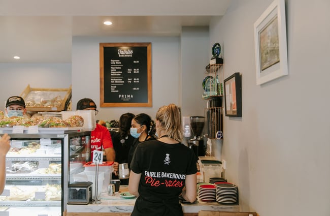 Staff milling about around the cafe's counter at Fairlie Bakehouse.